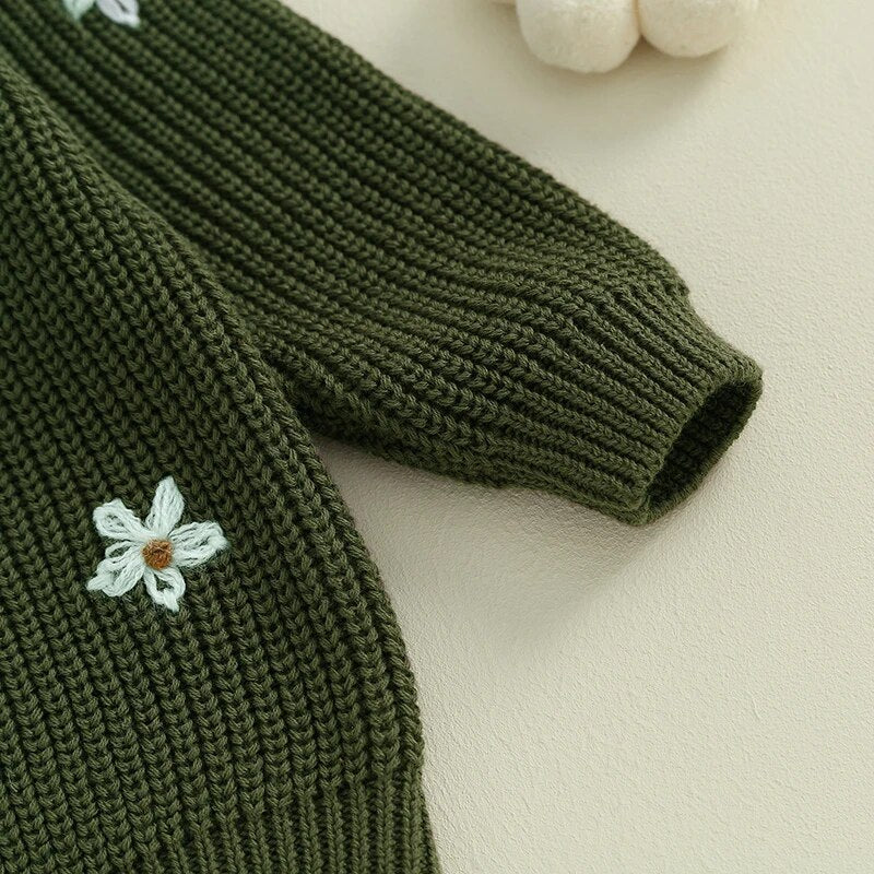 Closeup of front of sweater and sleeve for Green long sleeved knit sweater for baby girl and toddler girl with white floral embroidery, baby boutique, Jelly Bean Baby Co.