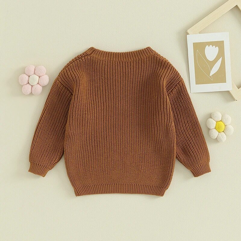 Solid back of Chestnut Yellow long sleeved knit sweater for baby girl and toddler girl with white floral embroidery, baby boutique, Jelly Bean Baby Co., on a decorated background